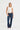 Woman wearing blue jeans with patterned studs on a white background