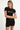 black shortsleeve knit romper with mother of pearl buttons at bust and waist