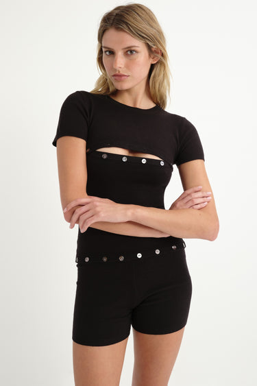black shortsleeve knit romper with mother of pearl buttons at bust and waist