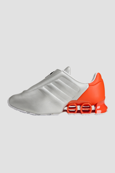 silver and orange adidas shoe with white sole and tongue zipper