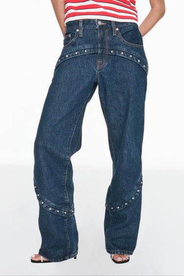 dark wash jean with stud details at hip and midcalf