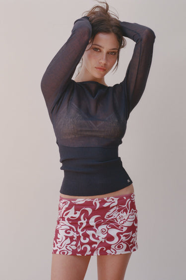 sheet navy sweater with ribbed waist and mini skirt with red-and-white hawaiian print