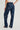 Woman wearing blue jeans with patterned studs on a white background