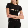 black shortsleeve knit romper with mother of pearl buttons at bust and waist