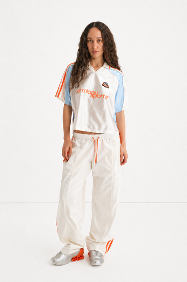 white adidas jersey and trackpant with orange stripes